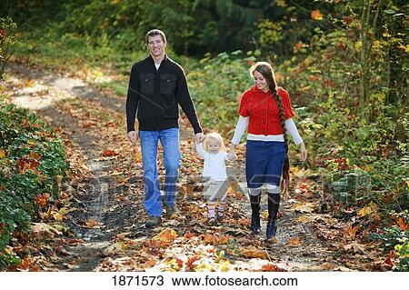 a family walking down a path in autumn View Large Photo Image Stock Image - a family walking down a path in autumn. Fotosearch