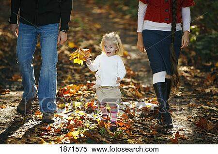a family walking on a path in autumn View Large Photo Image Stock Photography - a family walking on a path in autumn. Fotosearch