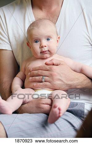 a father holding his infant View Large Photo Image Stock Image - a father holding his infant. Fotosearch