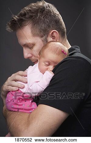 a father holds his infant daughter View Large Photo Image Stock Image - a father holds his infant daughter. Fotosearch
