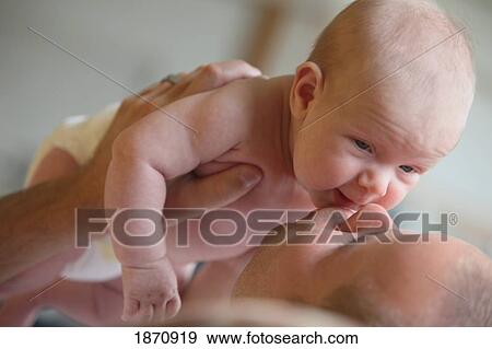 a father kissing his infant View Large Photo Image Stock Photo - a father kissing his infant. Fotosearch