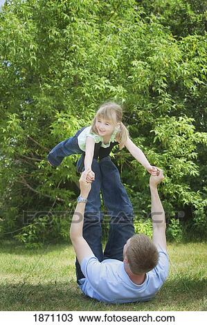 Stock Image - a father playing with his daughter. Fotosearch