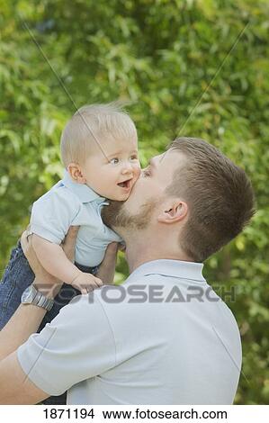 Picture - a father playing with his young son. Fotosearch