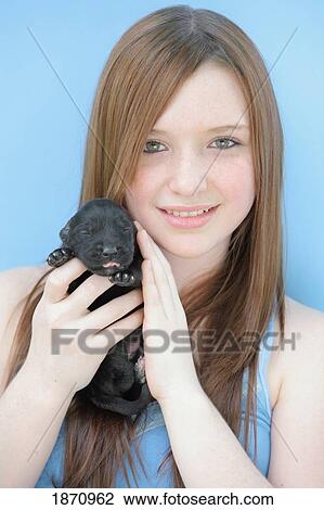 Stock Image - a girl and a new puppy. Fotosearch