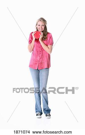 Picture - a girl holding a heart. Fotosearch