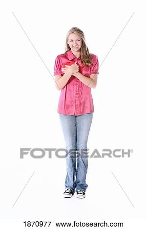 Stock Photo - a girl holding a heart to her chest. Fotosearch
