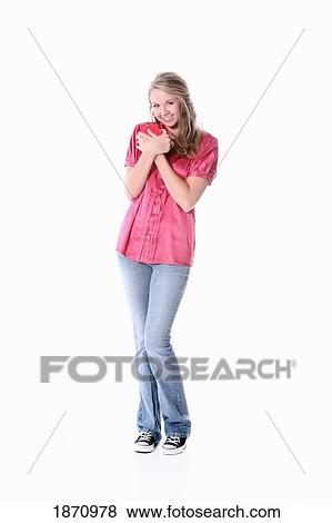 a girl holding a heart to her chest View Large Photo Image Stock Photo - a girl holding a heart to her chest. Fotosearch