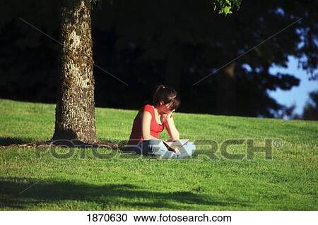 a girl reading a book in the park View Large Photo Image Stock Image - a girl reading a book in the park. Fotosearch