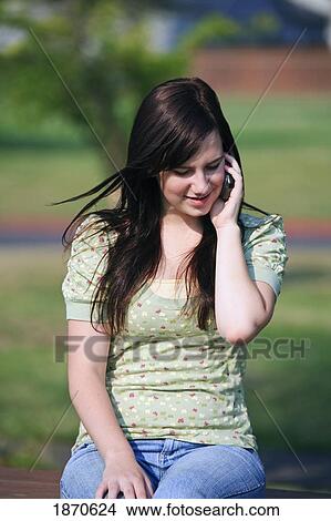 a girl talking on her cell phone View Large Photo Image Picture - a girl talking on her cell phone. Fotosearch