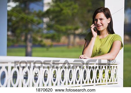 a girl talking on her cell phone View Large Photo Image Stock Image - a girl talking on her cell phone. Fotosearch