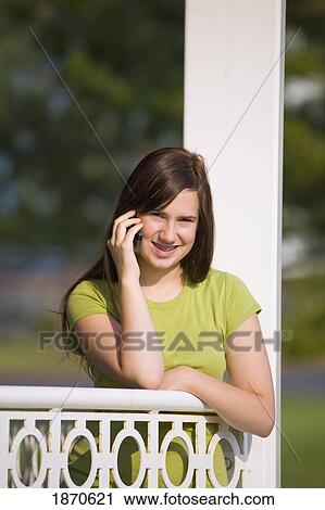 a girl talking on her cell phone View Large Photo Image Stock Image - a girl talking on her cell phone. Fotosearch