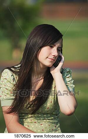 Stock Photography - a girl talking on her cell phone. Fotosearch