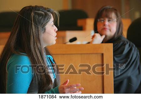 Picture - a girl talking to a judge. Fotosearch