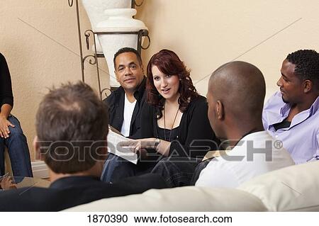 Stock Image - a group of adults in a home bible study. Fotosearch