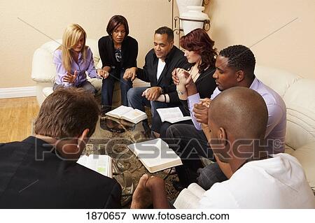 a group of adults meeting in a home with their bibles and praying View Large Photo Image Stock Photo - a group of adults meeting in a home with their bibles and praying. Fotosearch