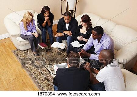 a group of adults praying with their bibles open View Large Photo Image Picture - a group of adults praying with their bibles open. Fotosearch