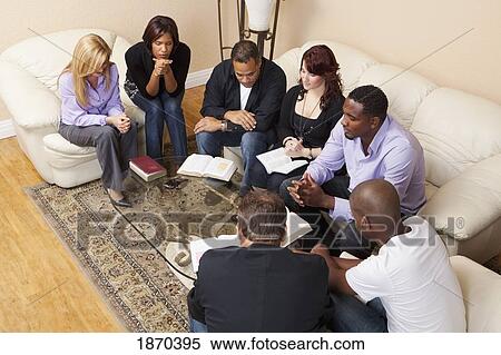 a group of adults praying with their bibles open View Large Photo Image Stock Photography - a group of adults praying with their bibles open. Fotosearch