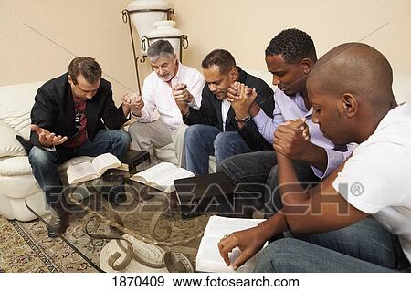 a group of men praying together View Large Photo Image Stock Photo - a group of men praying together. Fotosearch