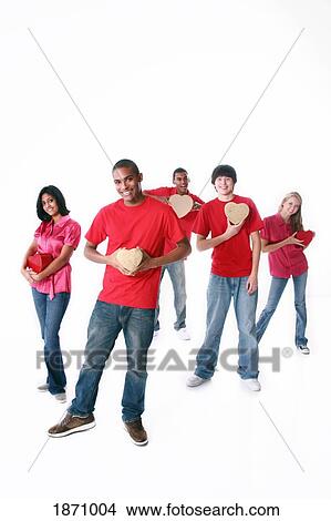 a group of teenagers holding hearts View Large Photo Image Picture - a group of teenagers holding hearts. Fotosearch