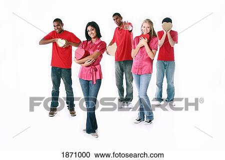 Stock Image - a group of teenagers holding hearts. Fotosearch