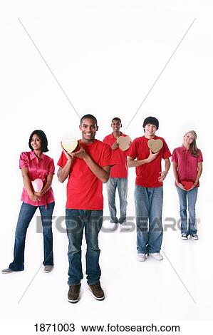 Stock Image - a group of teenagers holding hearts. Fotosearch