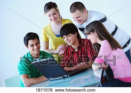 a group of teenagers looking at a laptop computer View Large Photo Image Stock Photo - a group of teenagers looking at a laptop computer. Fotosearch