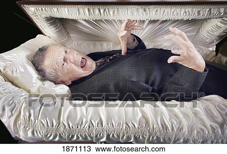 a man alive and laying in a coffin View Large Photo Image Stock Image - a man alive and laying in a coffin. Fotosearch