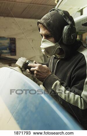 a man repairing a surfboard View Large Photo Image Stock Image - a man repairing a surfboard. Fotosearch