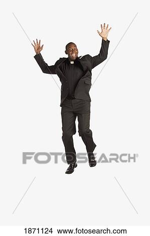 a man wearing a clerical collar and jumping in the air View Large Photo Image Picture - a man wearing a clerical collar and jumping in the air. Fotosearch