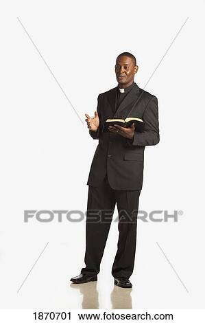 a man wearing a clerical collar and preaching from the bible View Large Photo Image Stock Image - a man wearing a clerical collar and preaching from the bible. Fotosearch