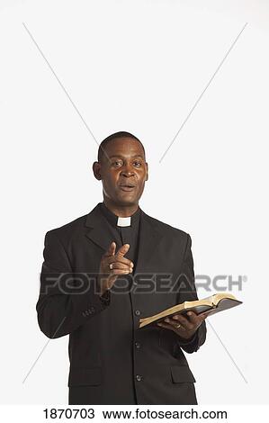a man wearing a clerical collar and preaching from the bible View Large Photo Image Stock Image - a man wearing a clerical collar and preaching from the bible. Fotosearch
