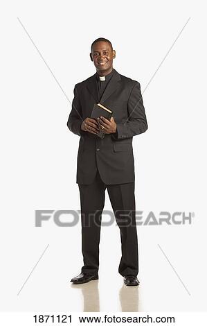 a man wearing a clerical collar and holding a bible View Large Photo Image Stock Image - a man wearing a clerical collar and holding a bible. Fotosearch