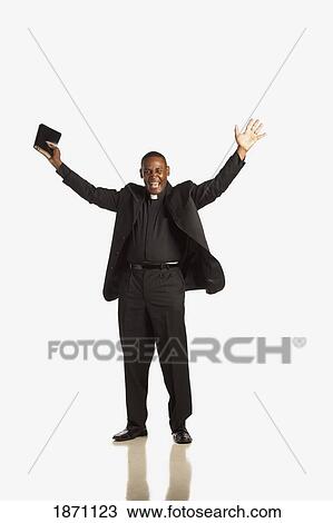 a man wearing a clerical collar and holding a bible with hands raised View Large Photo Image Stock Image - a man wearing a clerical collar and holding a bible with hands raised. Fotosearch