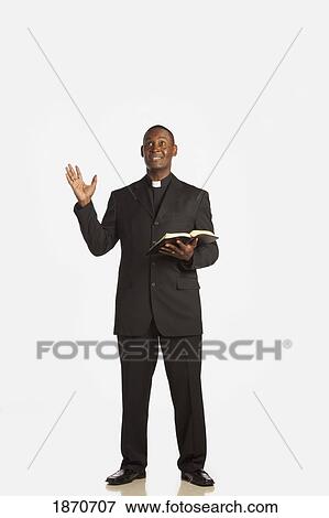 a man wearing a clerical collar and preaching from the bible View Large Photo Image Stock Photo - a man wearing a clerical collar and preaching from the bible. Fotosearch