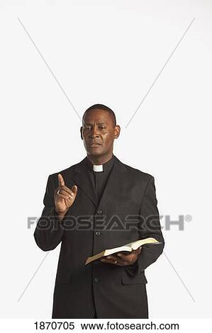 a man wearing a clerical collar and preaching from the bible View Large Photo Image Stock Photography - a man wearing a clerical collar and preaching from the bible. Fotosearch