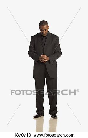 a man wearing a clerical collar with his head bowed in prayer View Large Photo Image Stock Image - a man wearing a clerical collar with his head bowed in prayer. Fotosearch