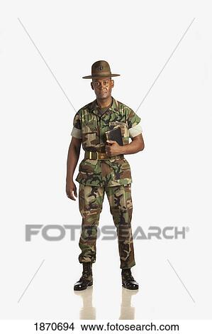 a military man holding a bible View Large Photo Image Picture - a military man holding a bible. Fotosearch