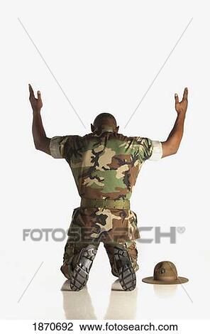 a military man kneeling with hands raised View Large Photo Image Stock Image - a military man kneeling with hands raised. Fotosearch