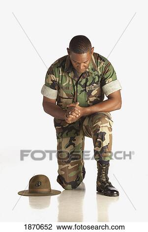 a military man praying on one knee View Large Photo Image Stock Image - a military man praying on one knee. Fotosearch