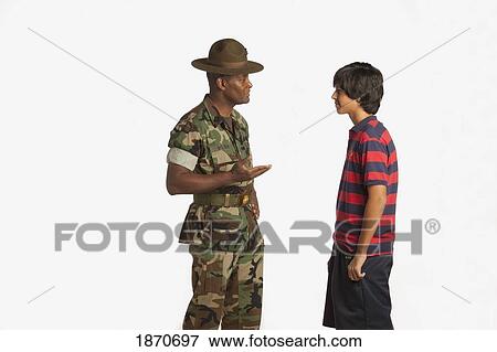 Stock Photo - a military man talking to a teenage boy. Fotosearch