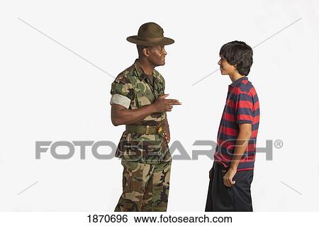 Stock Photograph - a military man talking to a teenage boy. Fotosearch