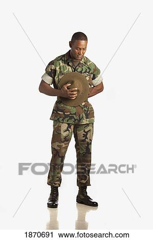 Stock Image - a military man with his head bowed in prayer. Fotosearch