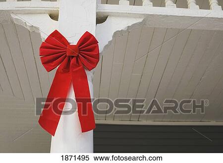 a red bow decorating the front of the house View Large Photo Image Stock Photography - a red bow decorating the front of the house. Fotosearch