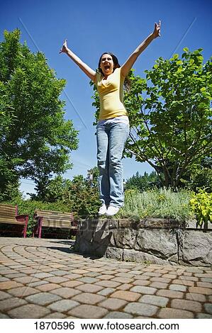 a teenage girl jumping in the air View Large Photo Image Stock Photograph - a teenage girl jumping in the air. Fotosearch