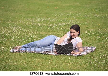 a teenage girl reading a book in the park View Large Photo Image Stock Image - a teenage girl reading a book in the park. Fotosearch