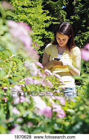 a teenage girl using her cell phone View Large Photo Image Stock Photo - a teenage girl using her cell phone. Fotosearch