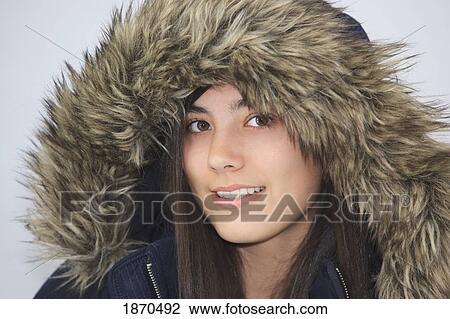 Stock Image - a teenage girl wearing a fur trimmed hood. Fotosearch