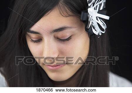 Stock Photograph - a teenage girl with a flower in her hair. Fotosearch
