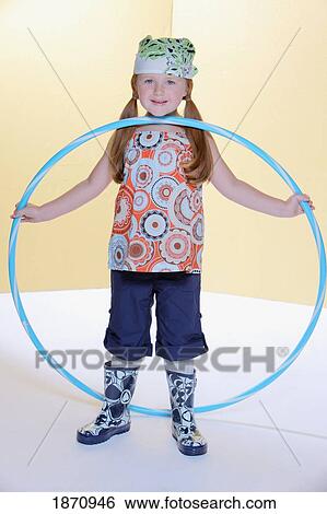 a young girl holding a hula hoop View Large Photo Image Stock Photograph - a young girl holding a hula hoop. Fotosearch