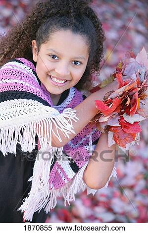 Stock Photography - a young girl holding leaves. Fotosearch